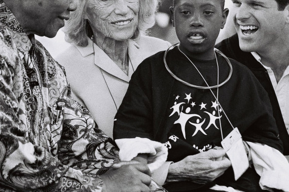 Sport has the power to change the world Special Olympics nutzt die Kraft des Sports, um die Welt inklusiver zu machen – Eunice Kennedy Shriver (M.) mit Special Olympics Athleten, ihrem Sohn Timothy (l.) und Nelson Mandela (r.)